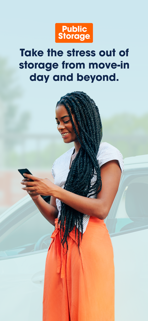 Public Storage - Smiling woman using the Public Storage mobile app next to a white car