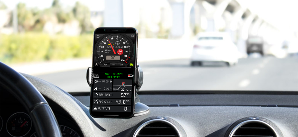 Speedometer ⊲ - iPhone montado en el panel de control de un coche mostrando la aplicación Velocímetro con datos de velocidad y viaje
