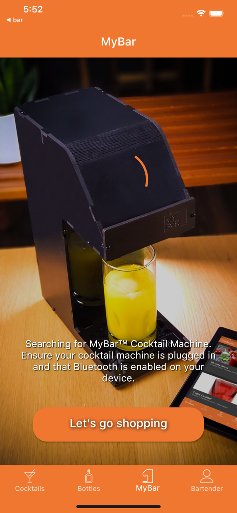 MyBar.io - An automated MyBar cocktail machine pouring a yellow drink into a glass while the app searches for a Bluetooth connection.