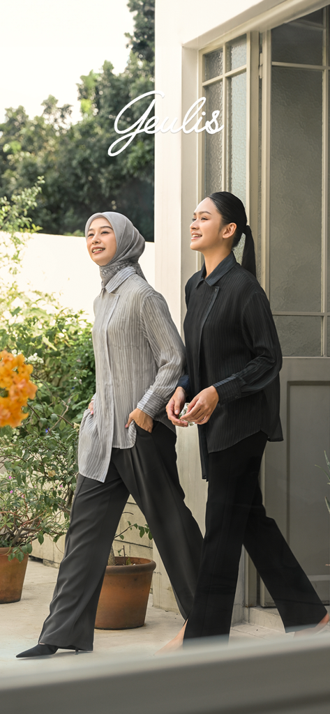 Two women wearing elegant modest fashion shirts and trousers from the Geulis collection