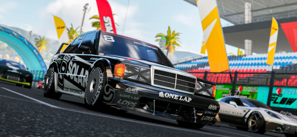 A black customized racing car with Solar decals on a professional race track with palm trees in the background