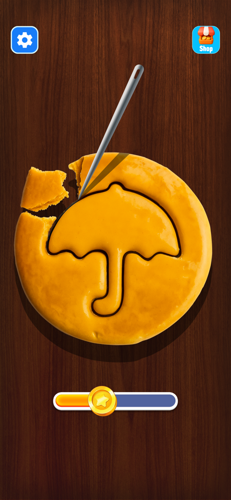 Uma agulha esculpindo um formato de guarda-chuva em um biscoito dalgona em um mini jogo relaxante.