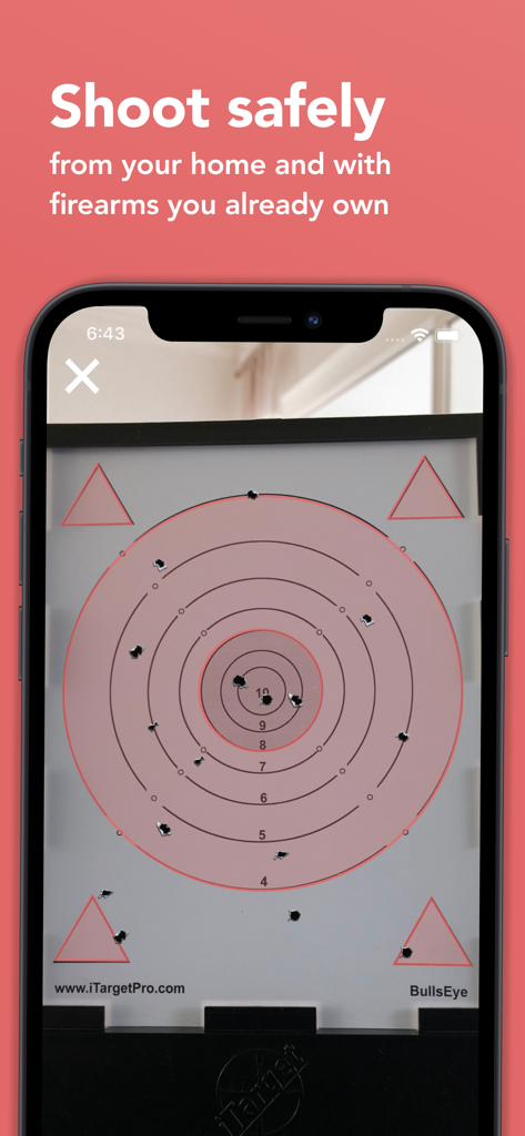 iTarget Pro - A smartphone screen showing the iTarget Pro app interface tracking laser hits on a physical target for safe home practice