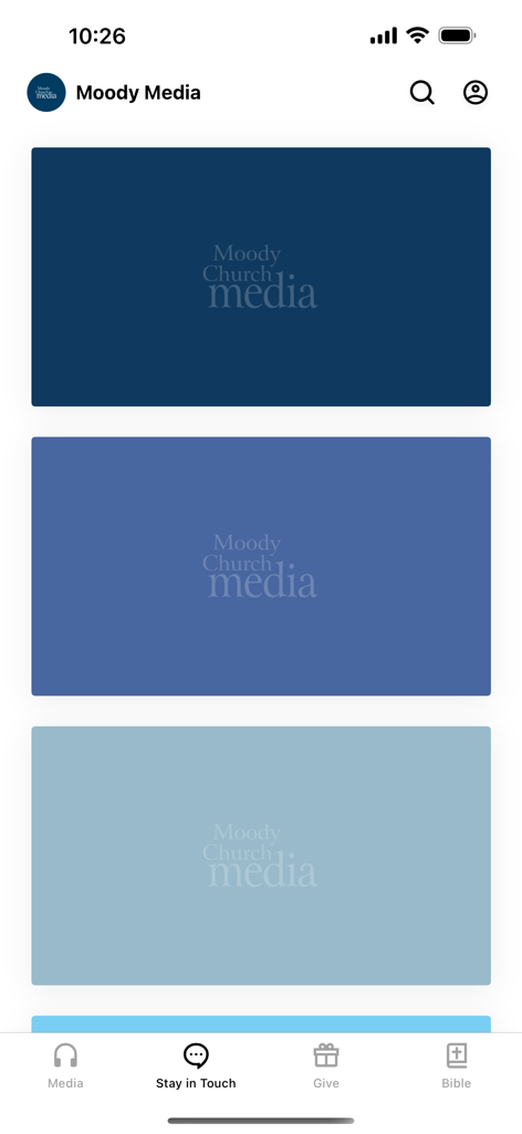 Home screen of the Moody Media app displaying media content options and a navigation bar with sections for Media, Stay in Touch, Give, and Bible.