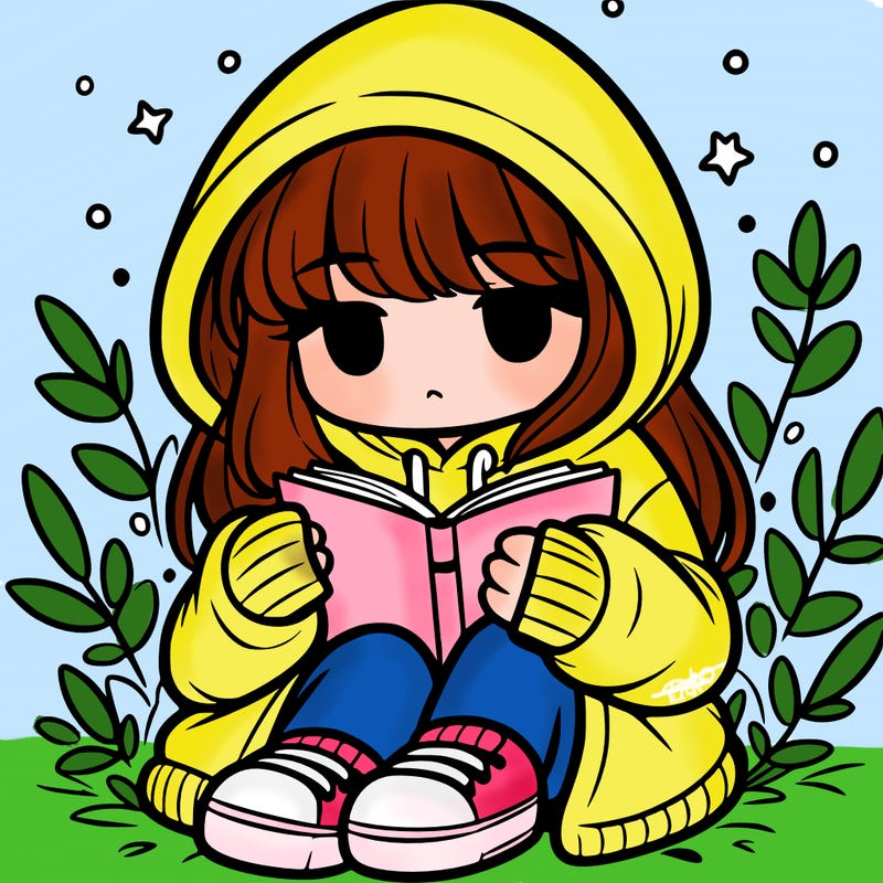 girl in oversized hoodie reading a book