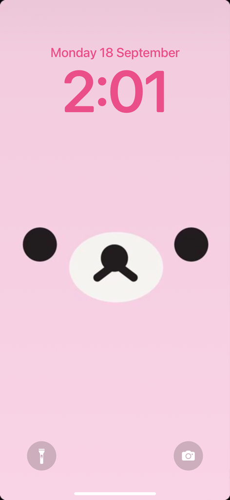A cute minimalist bear face illustration on a pink aesthetic lock screen background