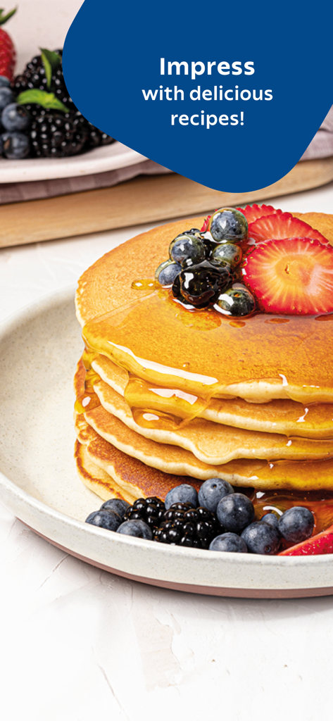 Tramontina Guru - A stack of fluffy pancakes with honey and fresh berries on a plate.