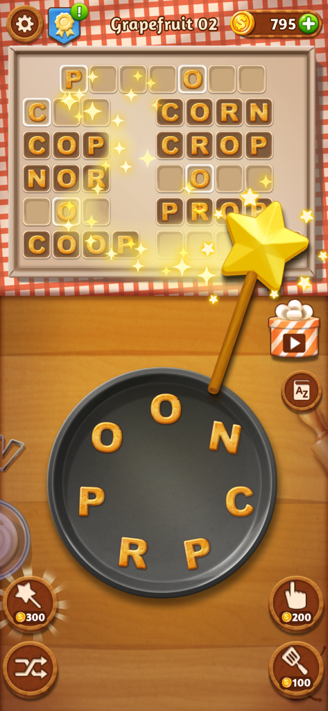 Word Cookies gameplay showing cookie-shaped letters on a pan and a word puzzle tray with a magic wand hint