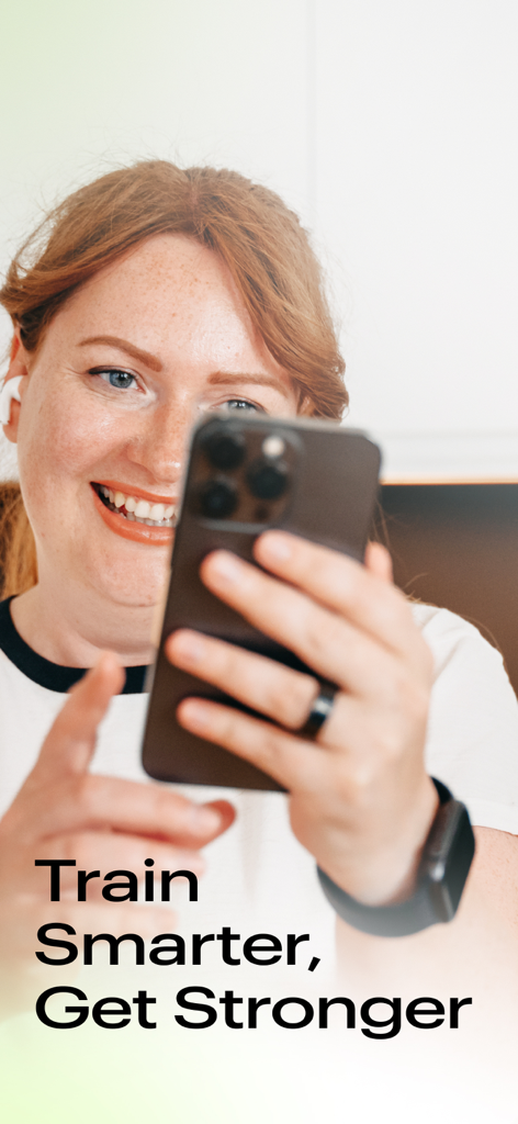 A smiling woman using the Fitify Gym app on her smartphone while wearing an Apple Watch