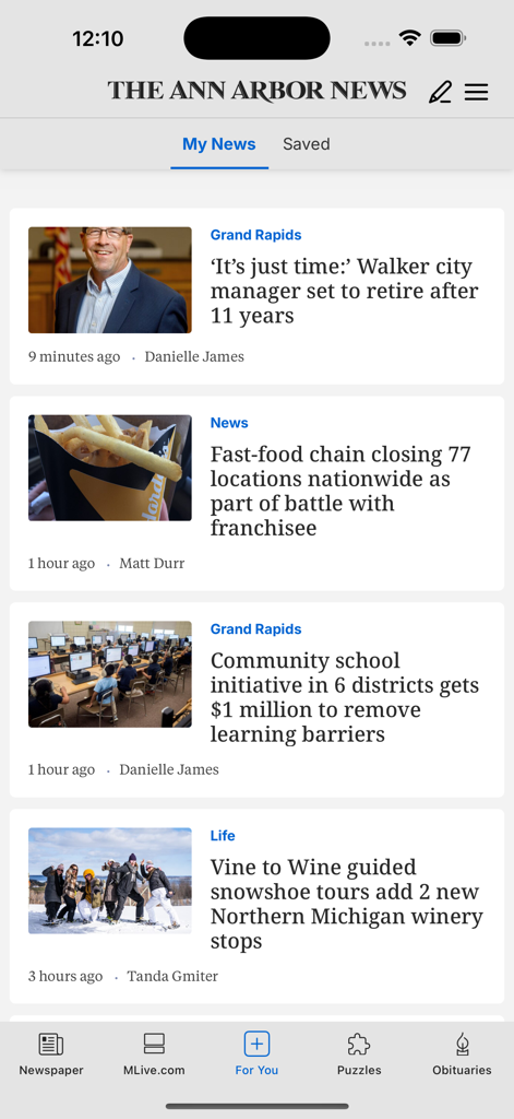 The Ann Arbor News mobile app interface showing a feed of local Michigan news stories.