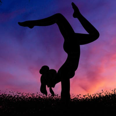 a woman doing a handstand