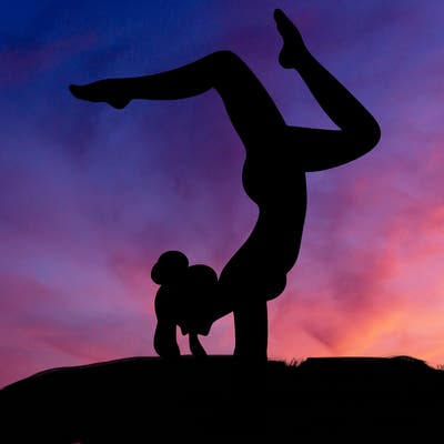 a woman doing a handstand