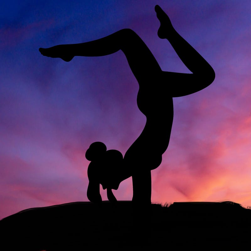 a woman doing a handstand