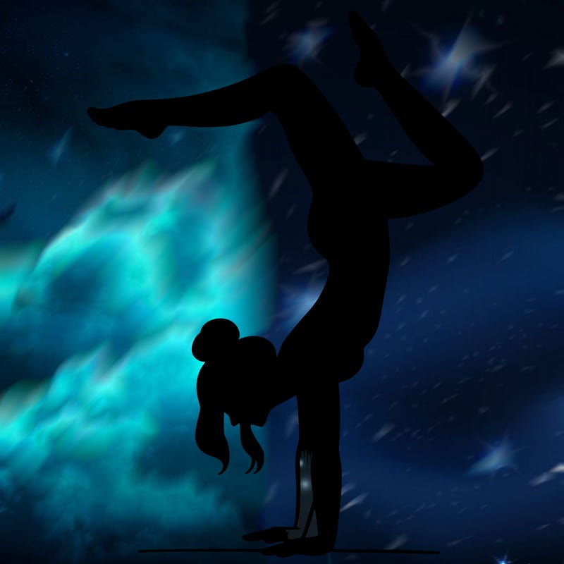 a woman doing a handstand