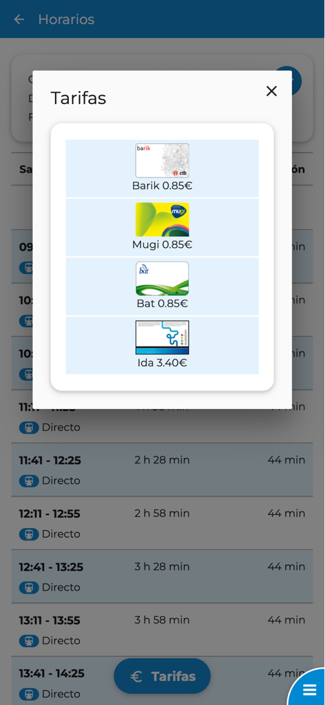 Euskal Tren, Metro y Tranvía - Pantalla de aplicación móvil que muestra los precios de los billetes de transporte público para las tarjetas Barik Mugi y Bat con horarios de trenes al fondo
