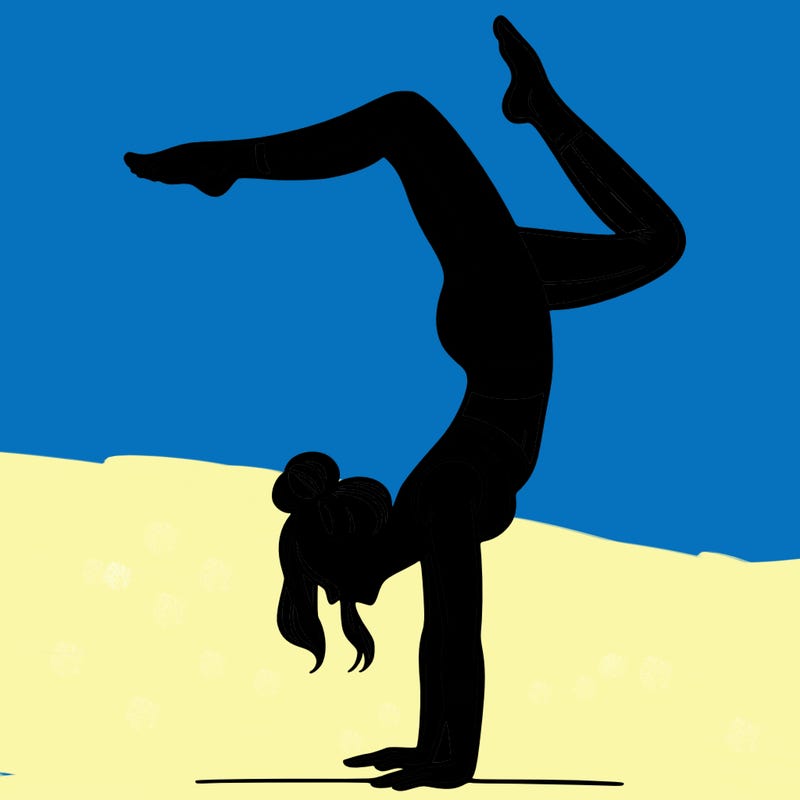 a woman doing a handstand