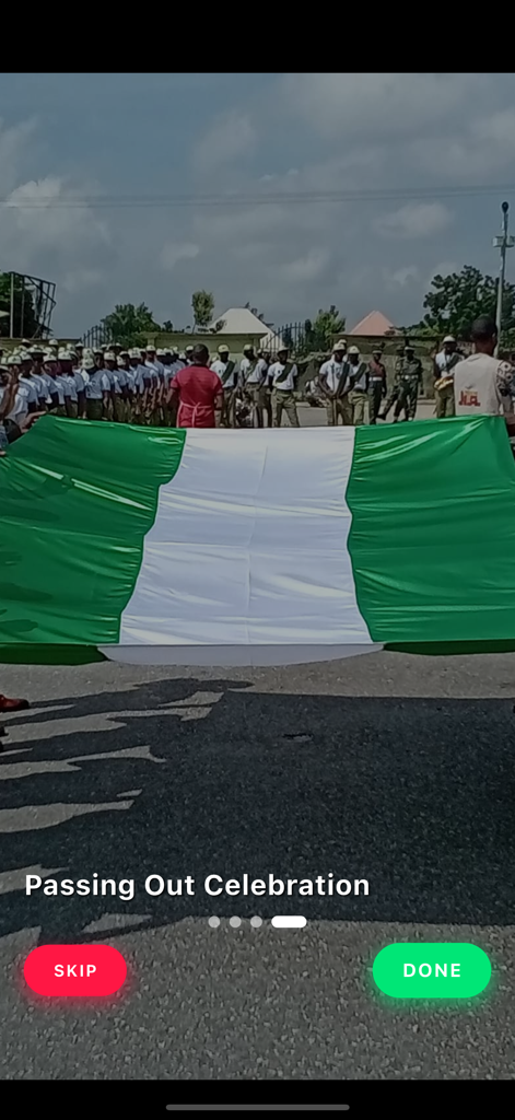 NYSC Official - Screen from the NYSC Official app showing a Passing Out Celebration with a large Nigerian flag and Corps Members.