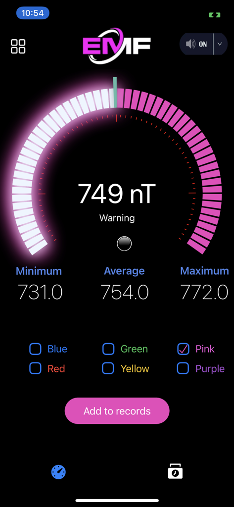 EMF Detector Radiation Reader app interface showing a 749 nanoTesla magnetic field measurement with a pink digital gauge.