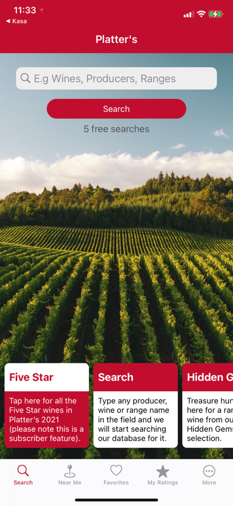 L'écran d'accueil de l'application Platters Wine Guide avec une barre de recherche et un arrière-plan pittoresque de vignoble