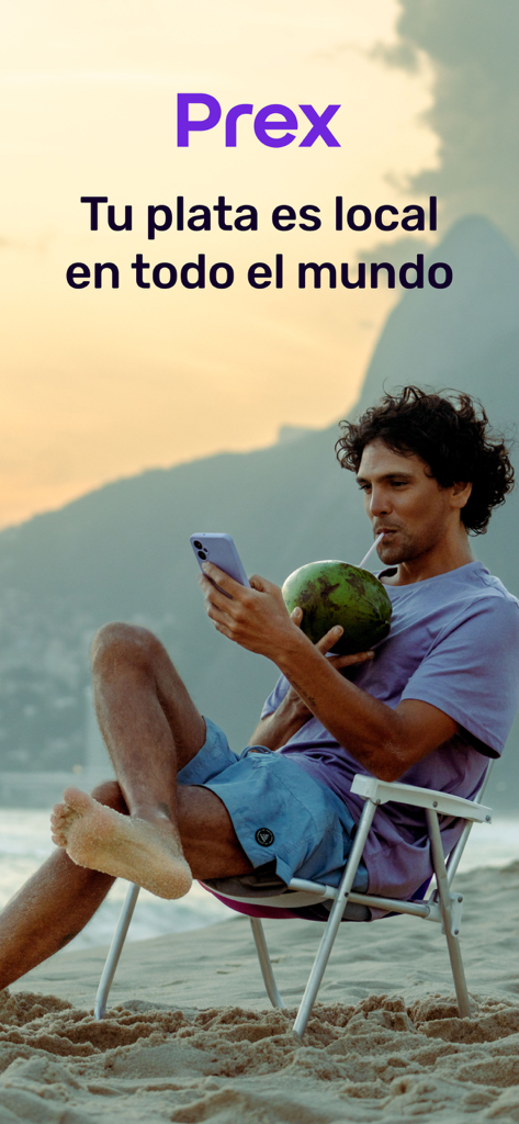 A man using the Prex Argentina app on his smartphone while relaxing on a beach with a coconut