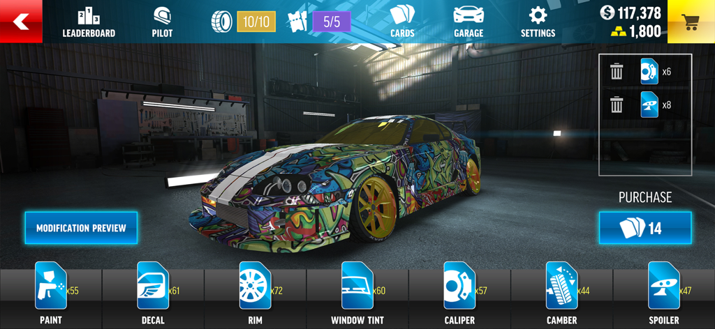 A sports car with colorful graffiti decals in the Drift Max Pro customization menu showing tuning options for rims and spoilers.