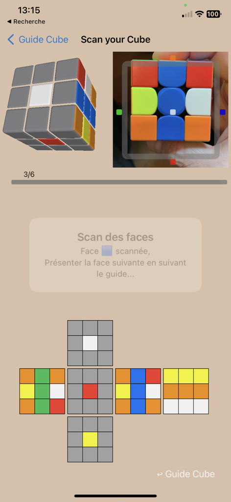 Smartphone app interface scanning a physical Rubiks cube using the camera for solving