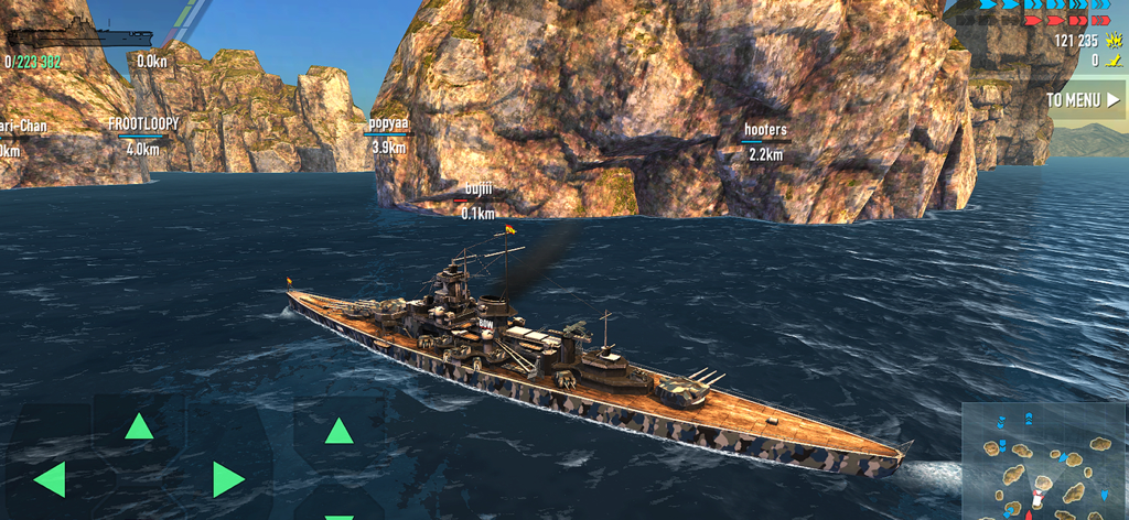 Battle of Warships: Naval Wars - A detailed 3D battleship navigating through ocean waters near rocky cliffs in a naval combat simulation.