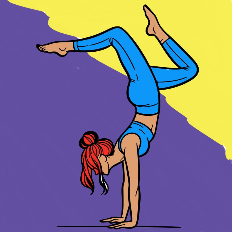 a woman doing a handstand