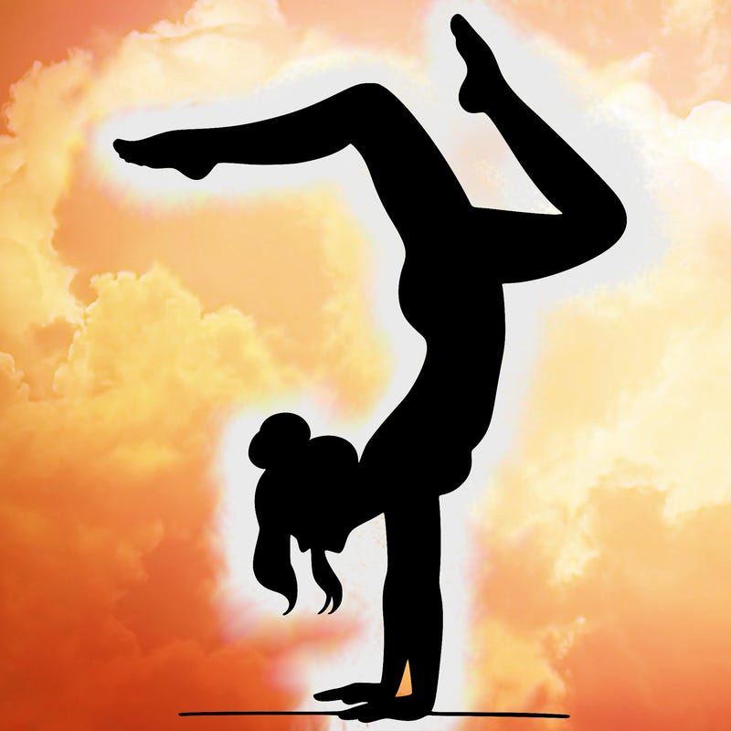 a woman doing a handstand