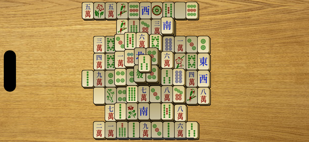 Classic Mahjong board with large tiles on a wooden background