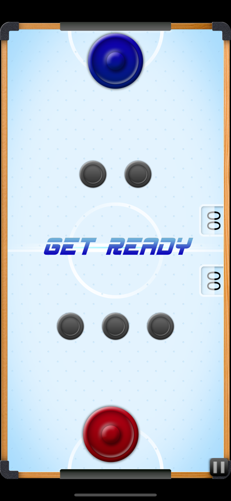 A top down view of a digital air hockey table with blue and red mallets and multiple pucks