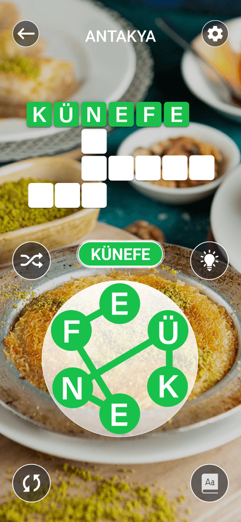 Kelime Gezmece - A screenshot of the Kelime Gezmece word puzzle game showing a level in Antakya with a crossword and letter wheel