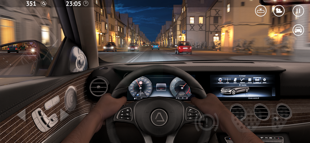 Interior dashboard view of a car driving through a German town at night