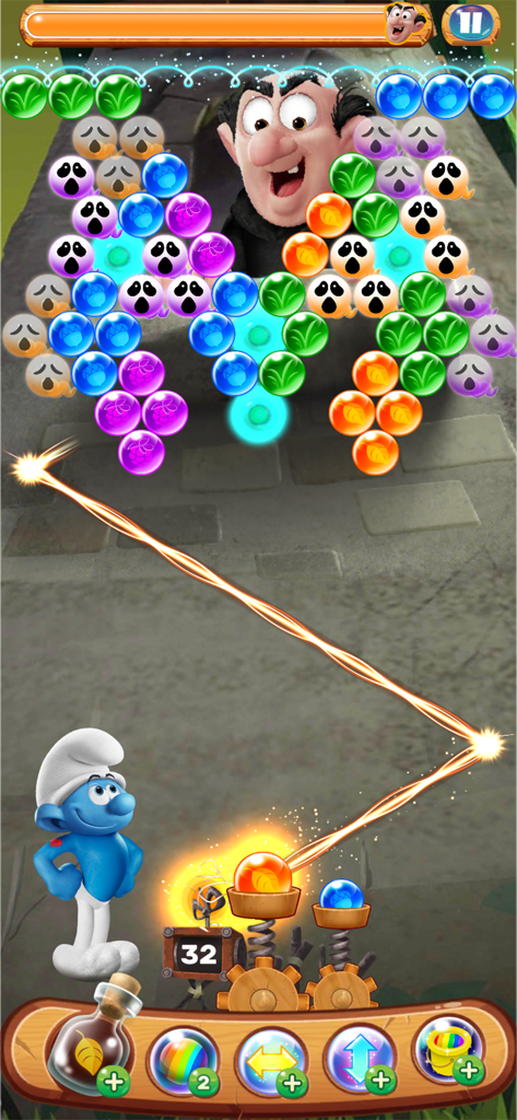 Hefty Smurf aiming a bubble shooter in a level featuring Gargamel and colorful puzzle bubbles