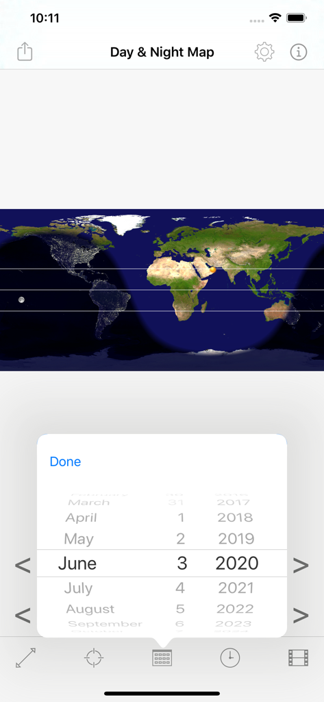 Screenshot of Day and Night Map app showing a world map with day and night regions and a date selector wheel.