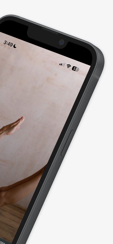 A woman performing a Pilates exercise on the Shape Pilates London app shown on an iPhone screen.