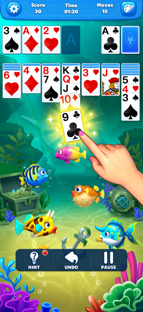 A classic solitaire card game interface with an underwater aquarium theme featuring colorful fish and coral