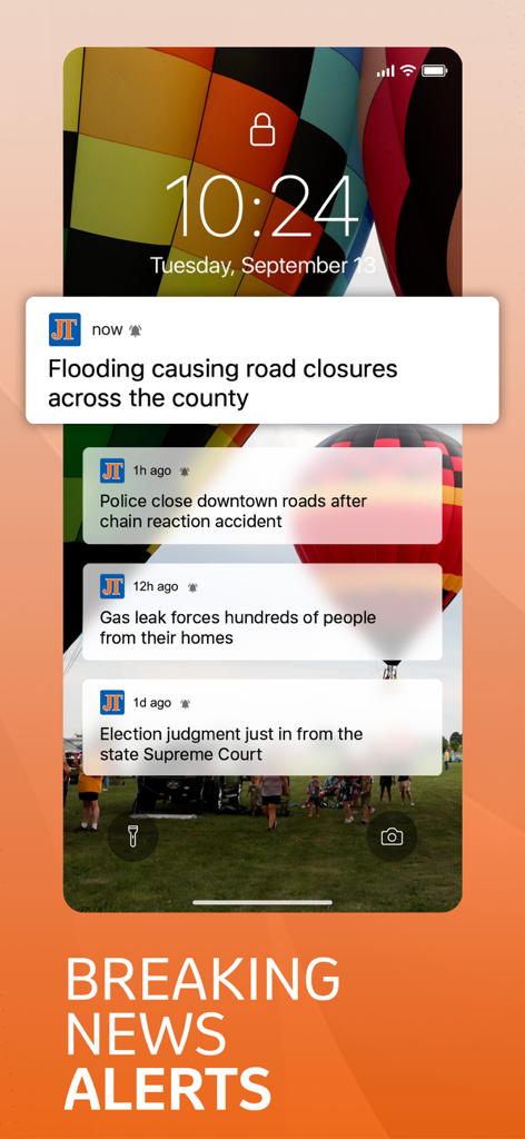 iPhone lock screen showing multiple breaking news notifications from the Journal Times app about local flooding, accidents, and election updates