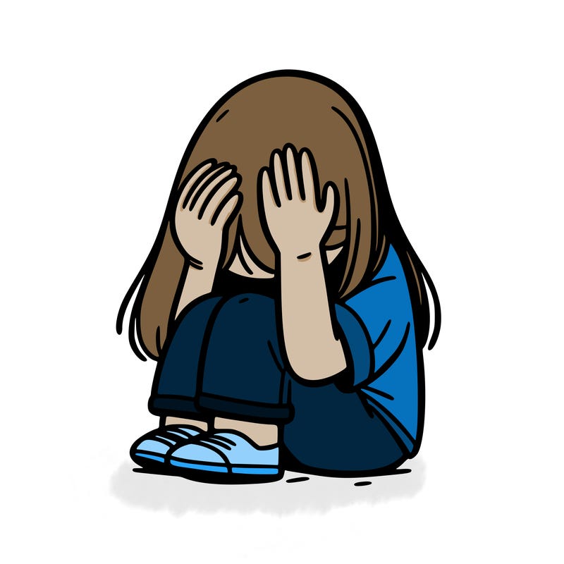 girl sitting down covering her head