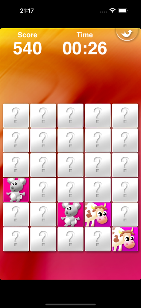 A children's memory matching game screen showing a grid of cards with a koala and a cow revealed
