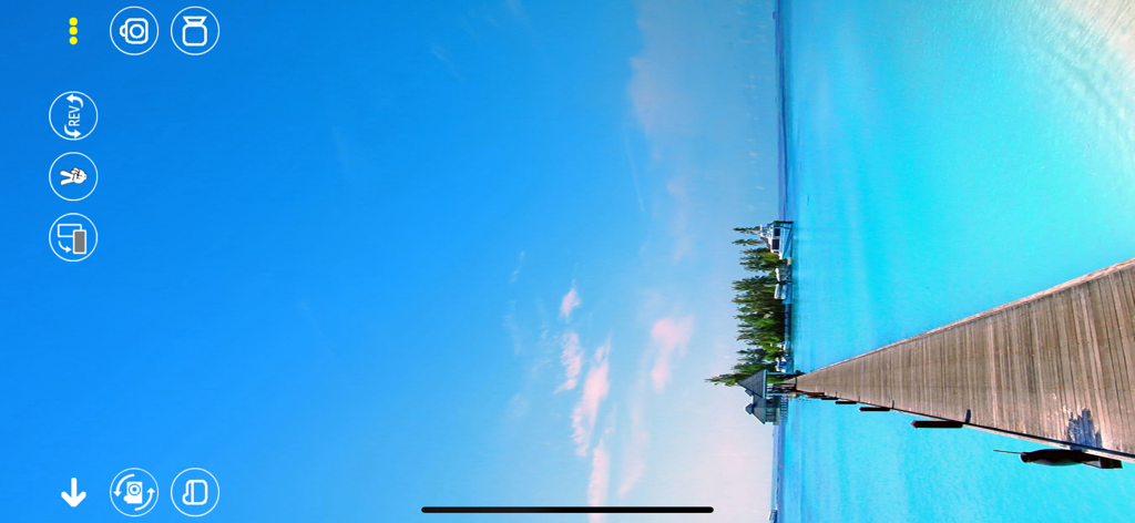 RC UFO - RC UFO app interface showing a live drone camera feed of a pier over tropical water