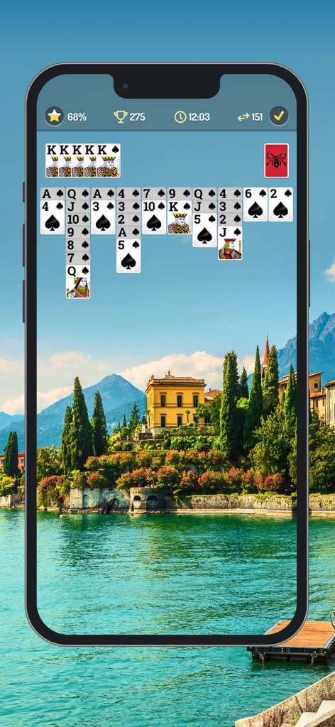 Juego de Spider Solitaire con cartas de fuente grande y fondo de paisaje escénico.