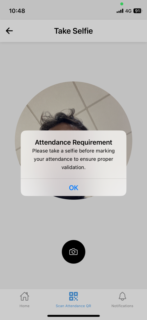 A prompt in the iCloudEMSV2 app requiring a selfie for attendance validation.