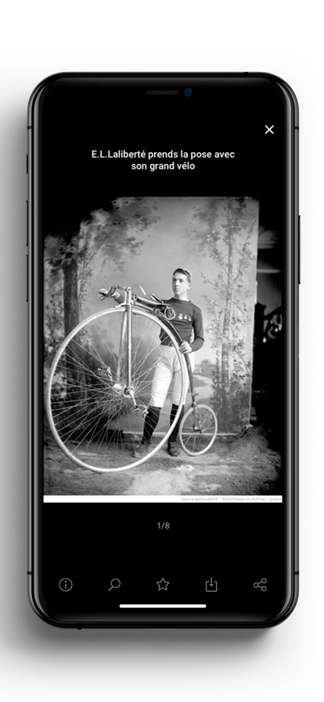 Gallica - Black and white historical photograph of a man posing with a penny-farthing bicycle on the Gallica mobile app