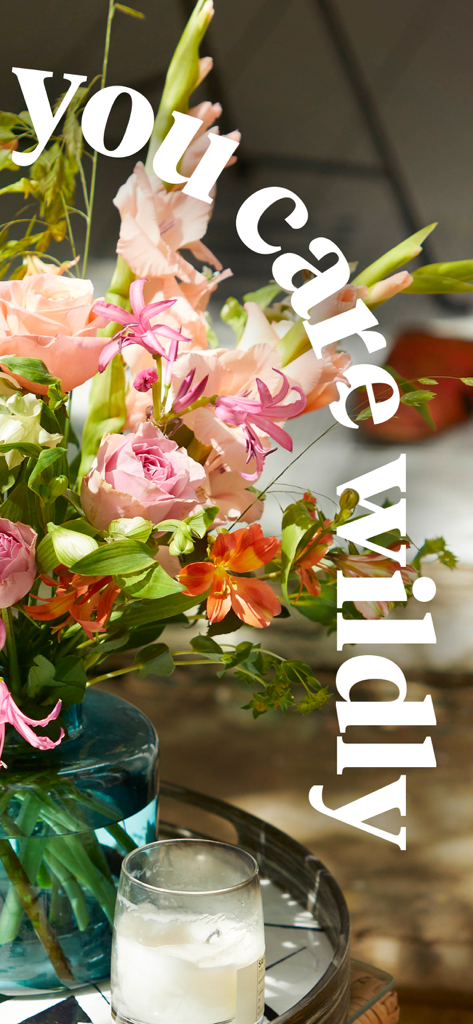 Bloom & Wild - Flowers & Gifts - 파란색 유리 꽃병에 담긴 손꽃다발과 당신을 열정적으로 사랑한다는 텍스트.