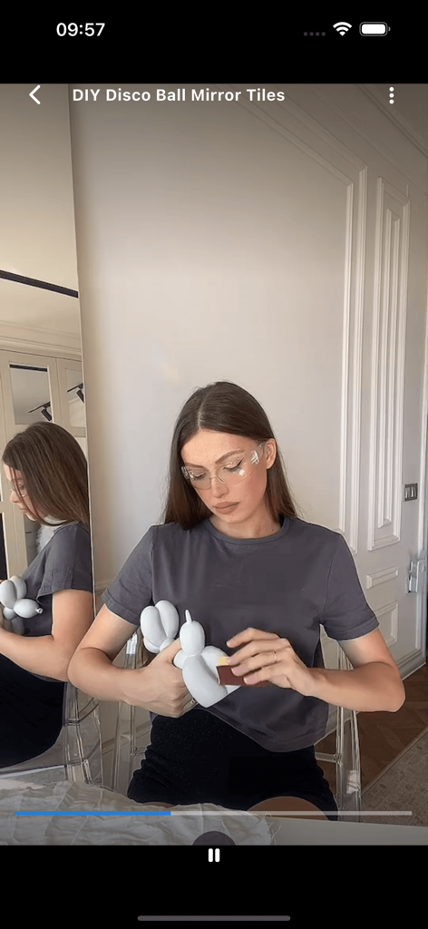 Woman wearing safety glasses crafting a DIY disco ball mirror project