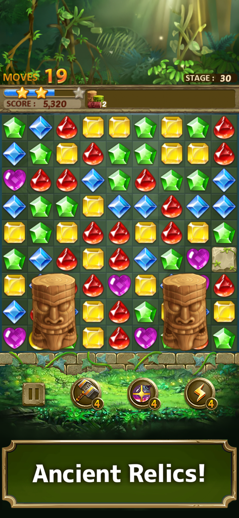A match 3 puzzle board from Jewels Jungle showing colorful gems and wooden tiki relics