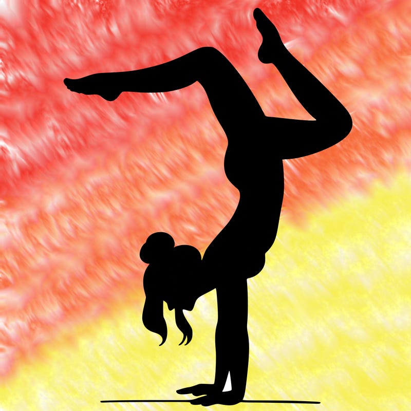 a woman doing a handstand