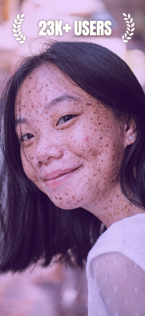 Portrait of a smiling young woman with freckles and text overlay showing over 23 thousand users for the AI attractiveness test app