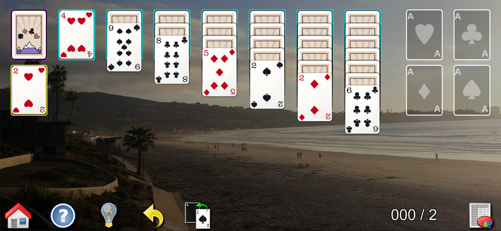 Classic solitaire game with large cards and a relaxing beach sunset background.